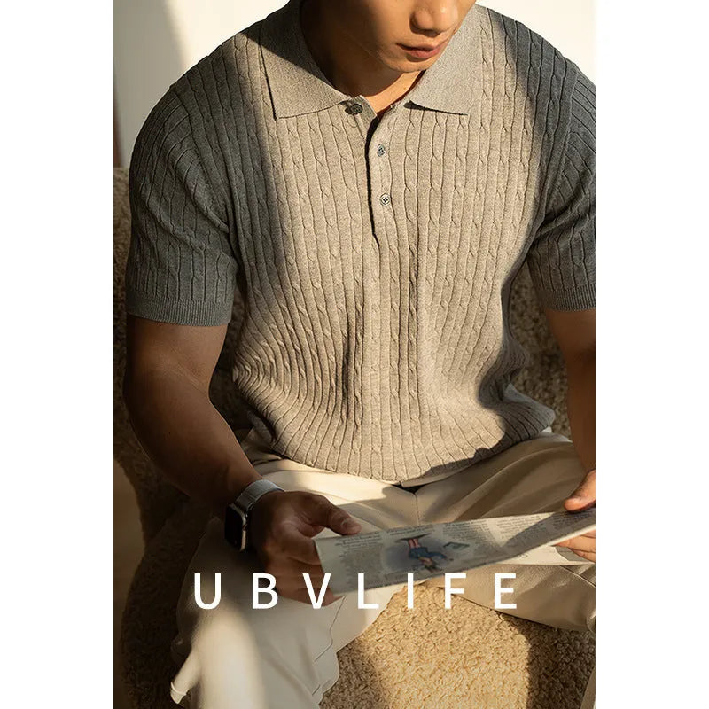 Men's khaki short sleeve business top on a hanger, showing the collar and button placket.