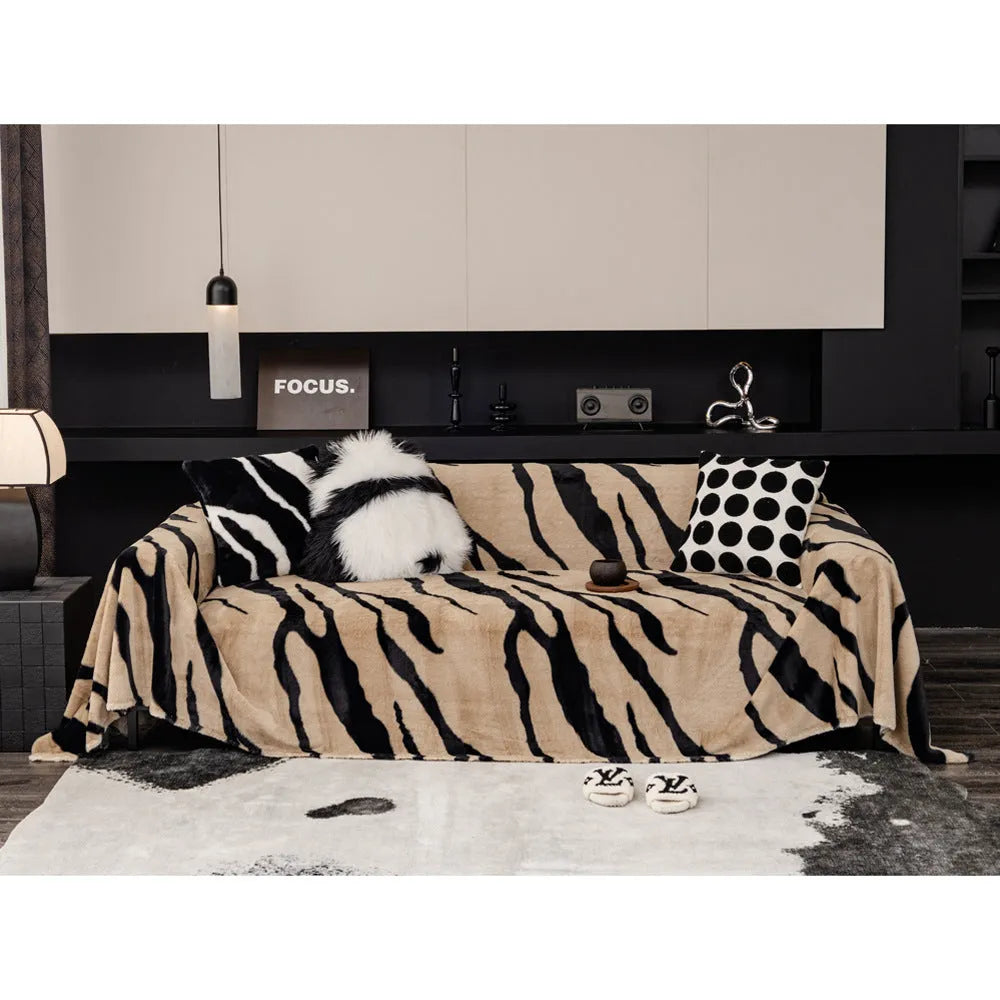 Zebra pattern flannel sofa cover in caramel colour on grey sofa, showing thickened non-slip construction.