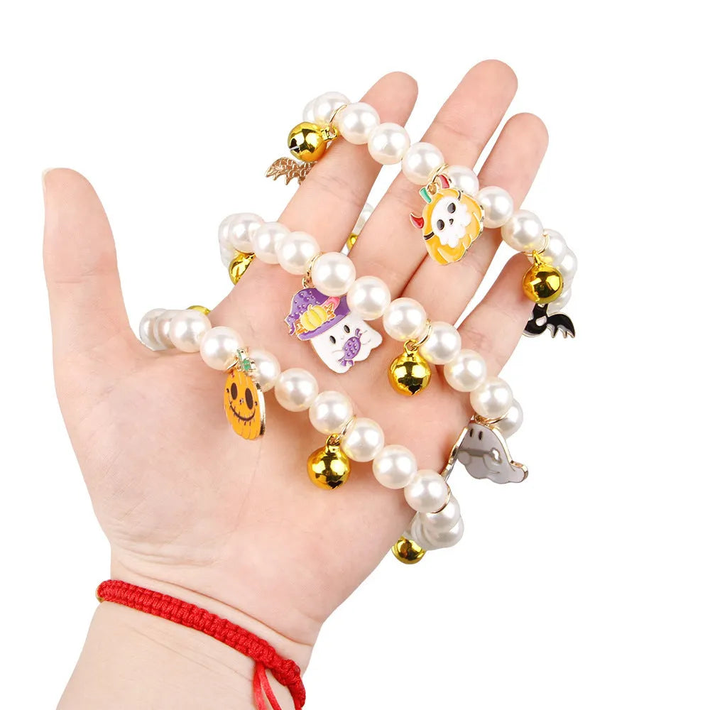 Decorative Halloween cat collar with simulated pearls and pumpkin charm in purple ghost design
