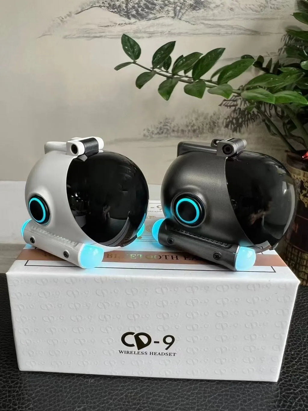 A black or white clip-type wireless Bluetooth headset for sports and hands-free calls.