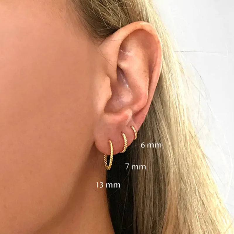 A pair of twisted sterling silver round ring earrings in a gold colour finish, shown at 13mm size.