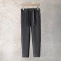 Boys slim straight wool trousers in tapered cut showing straight leg opening in neutral colour