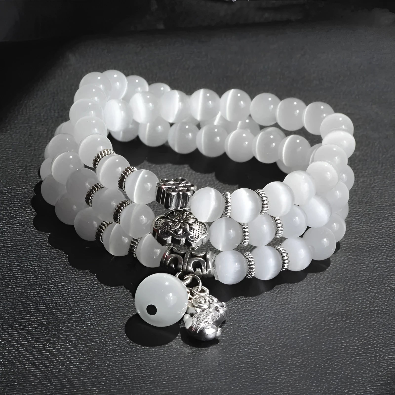 Opal cat eye bracelet with three geometric rings and lucky cat charms on adjustable 52cm cord