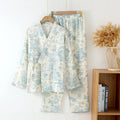 Women's pink cotton gauze lounge suit set with long sleeves and elastic waist trousers laid flat.