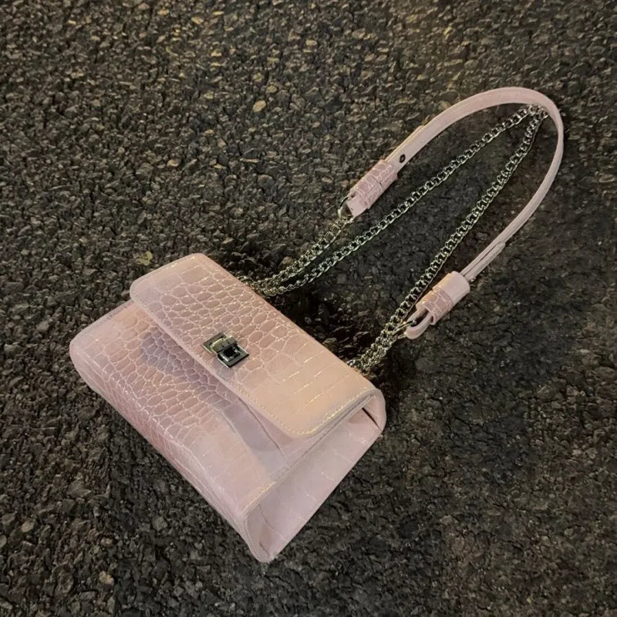 Black polyester fibre crossbody bag with chain strap, bow tie accent, and small square shape for everyday commuting