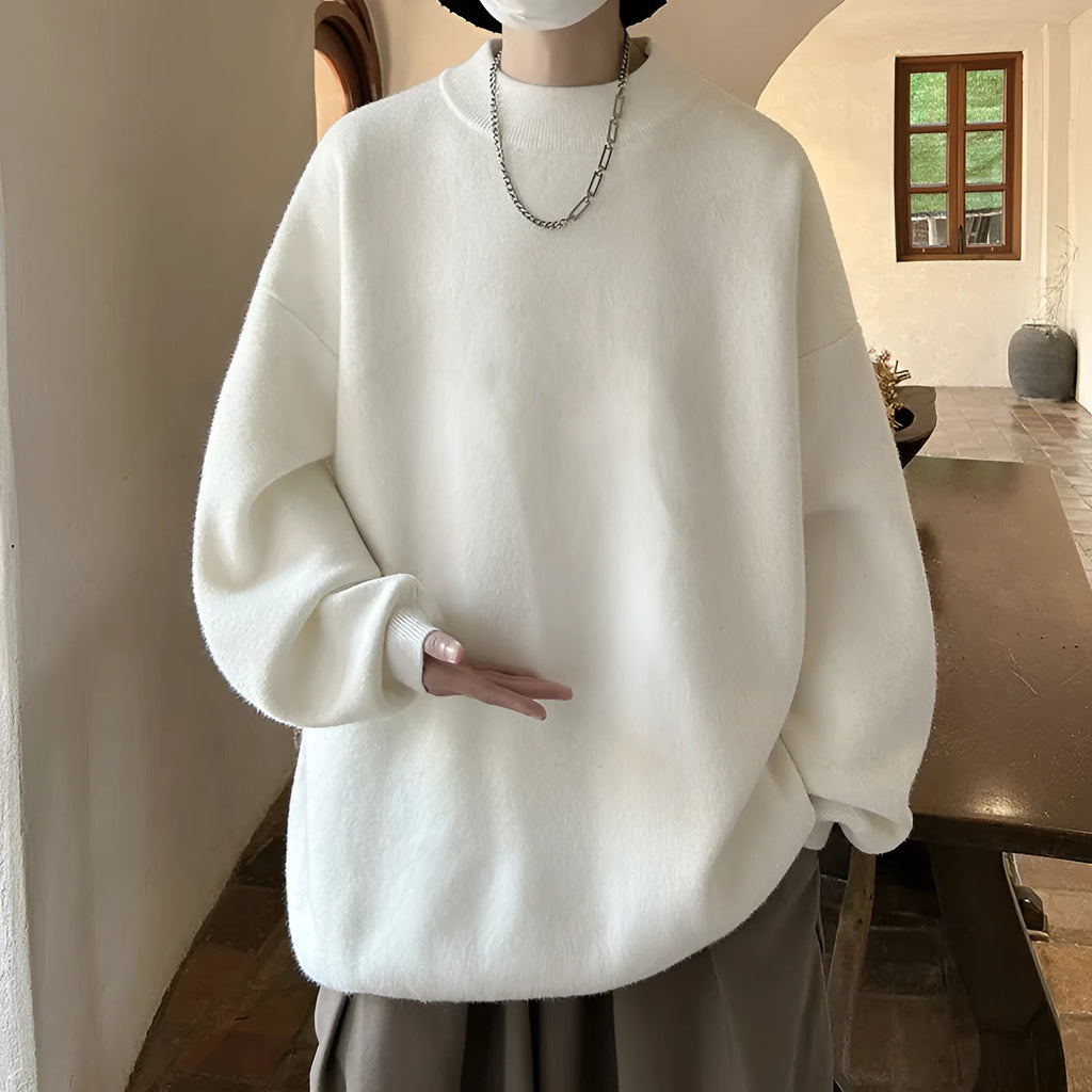 Man wearing a loose grey round neck long sleeve polyester sweater for casual spring or autumn attire.