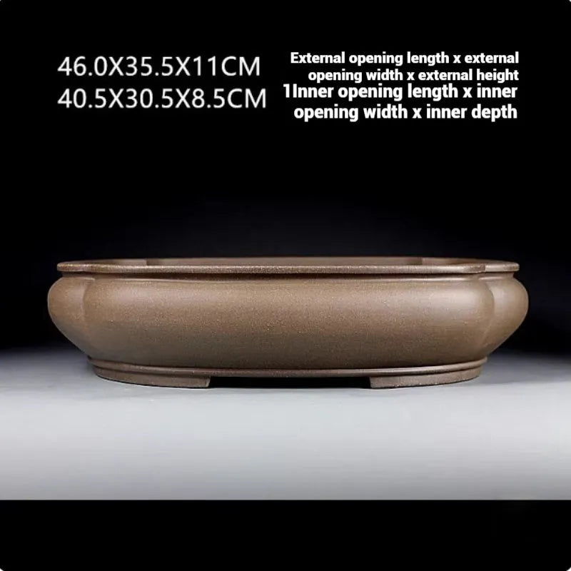 Handmade antique Pukou style papaya-shaped purple clay flower pot on a table.