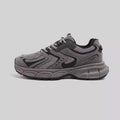 Grey chunky platform sneakers with leather stitching and lace-up design on a white background.