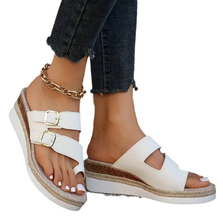 White patent leather women's wedge sandals with peep toe and woven detail on a rubber sole.