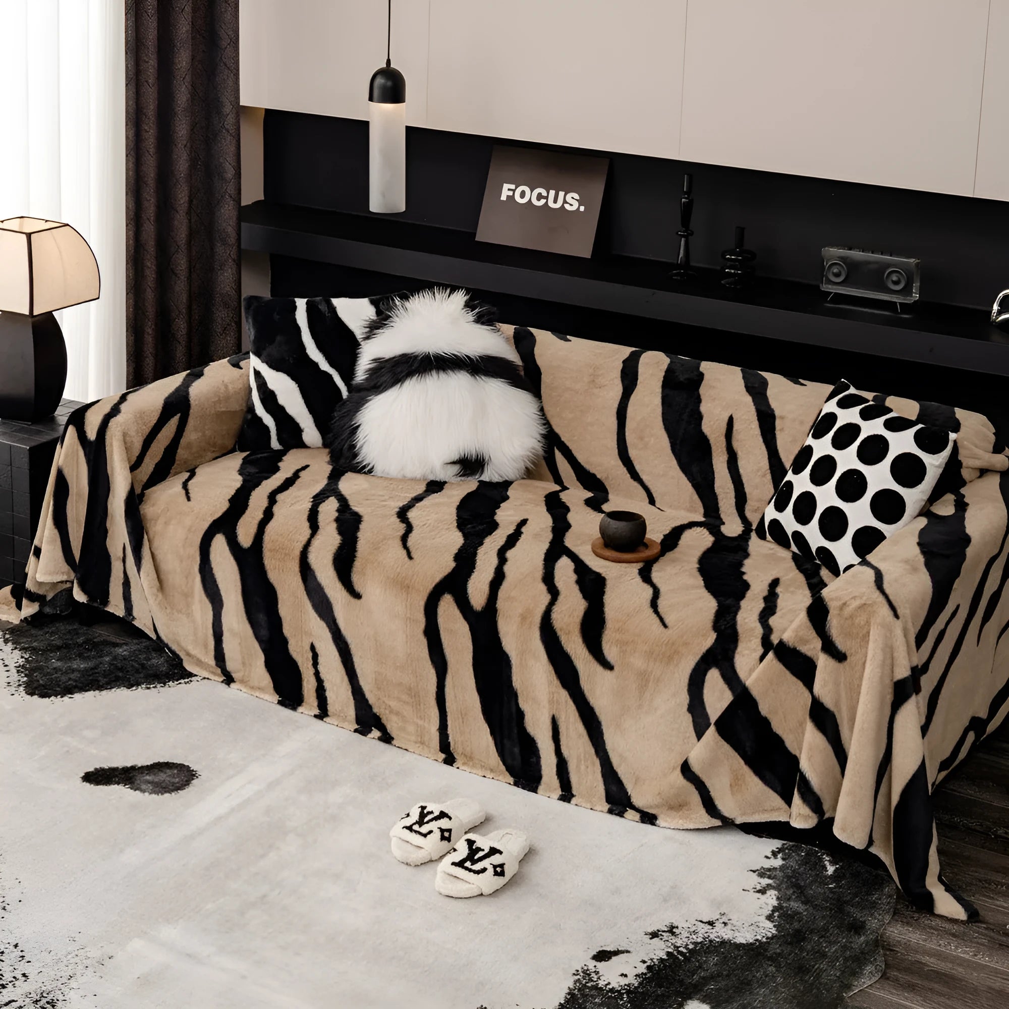 Zebra pattern flannel sofa cover in caramel colour on grey sofa, showing thickened non-slip construction.