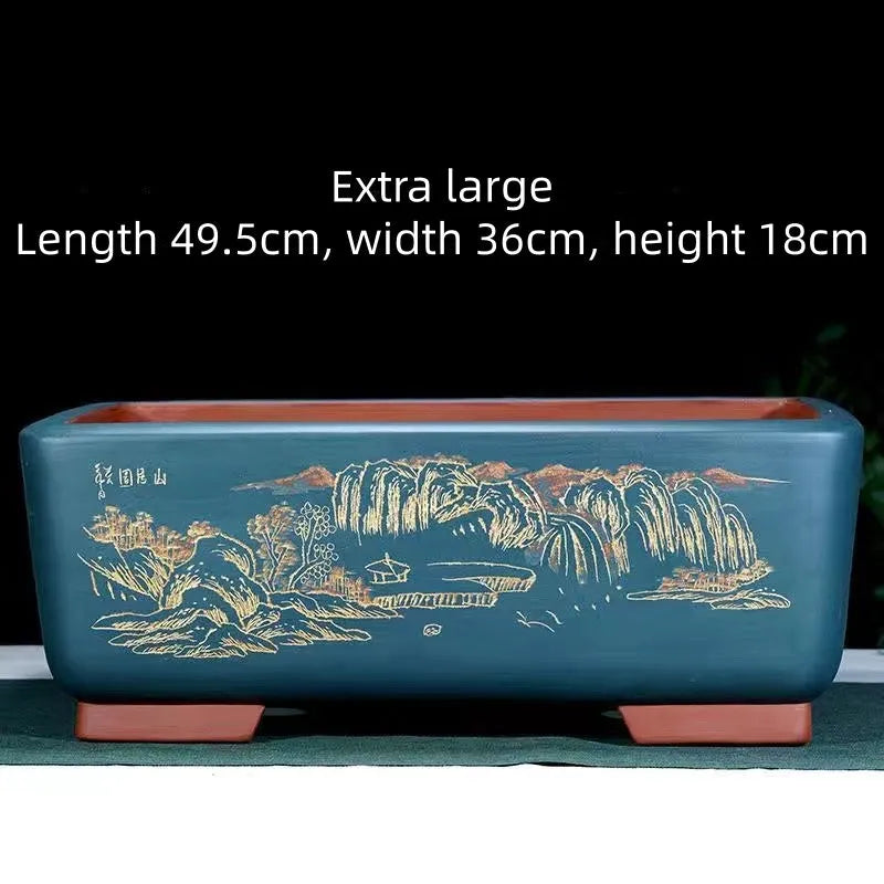 A deep blue black handmade rectangular purple clay bonsai pot on a wooden surface.