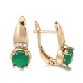 Rose gold plated copper stud earrings with emerald green zircon stone in U-shaped retro design on white background
