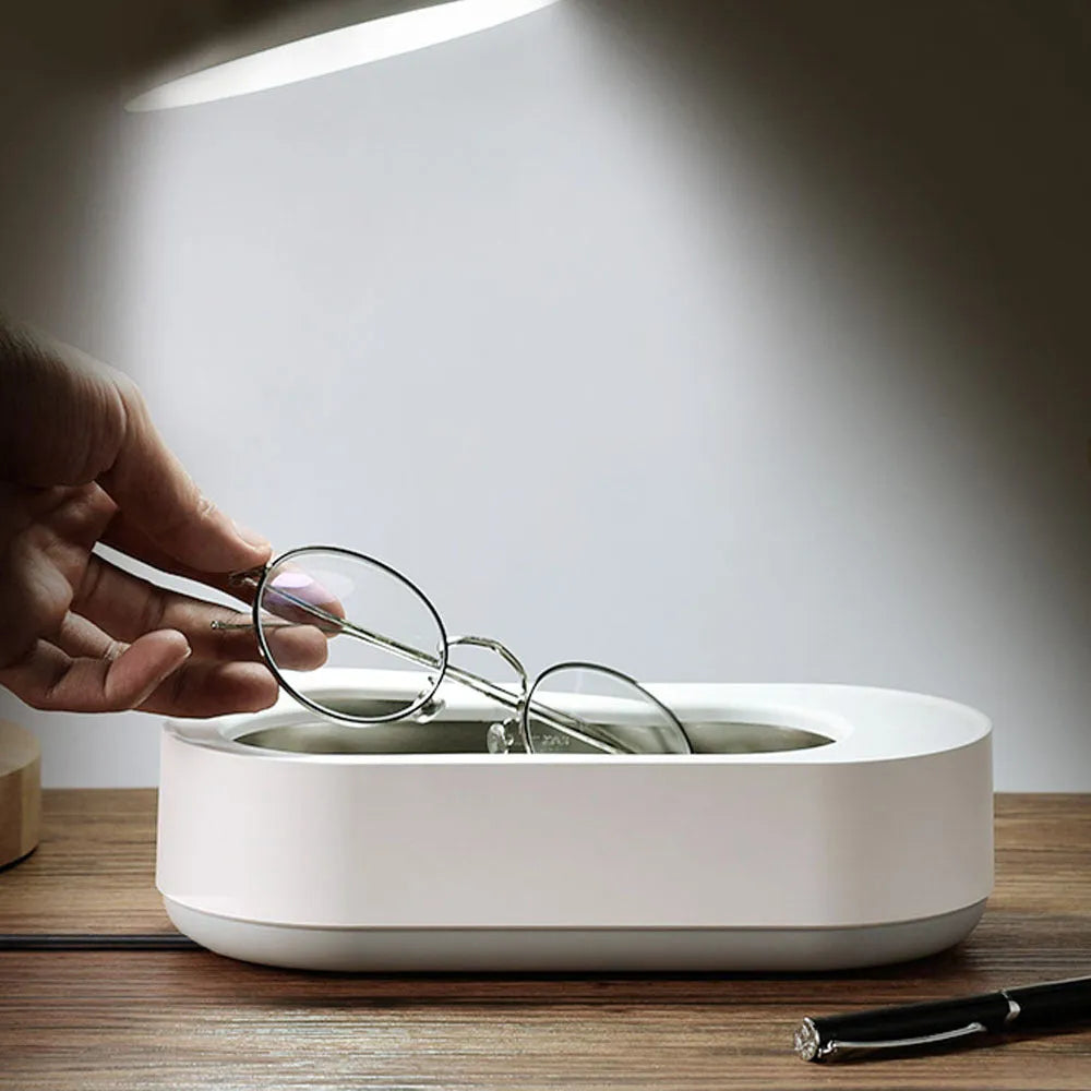 White portable ultrasonic cleaning machine with stainless steel tank and digital timer display.