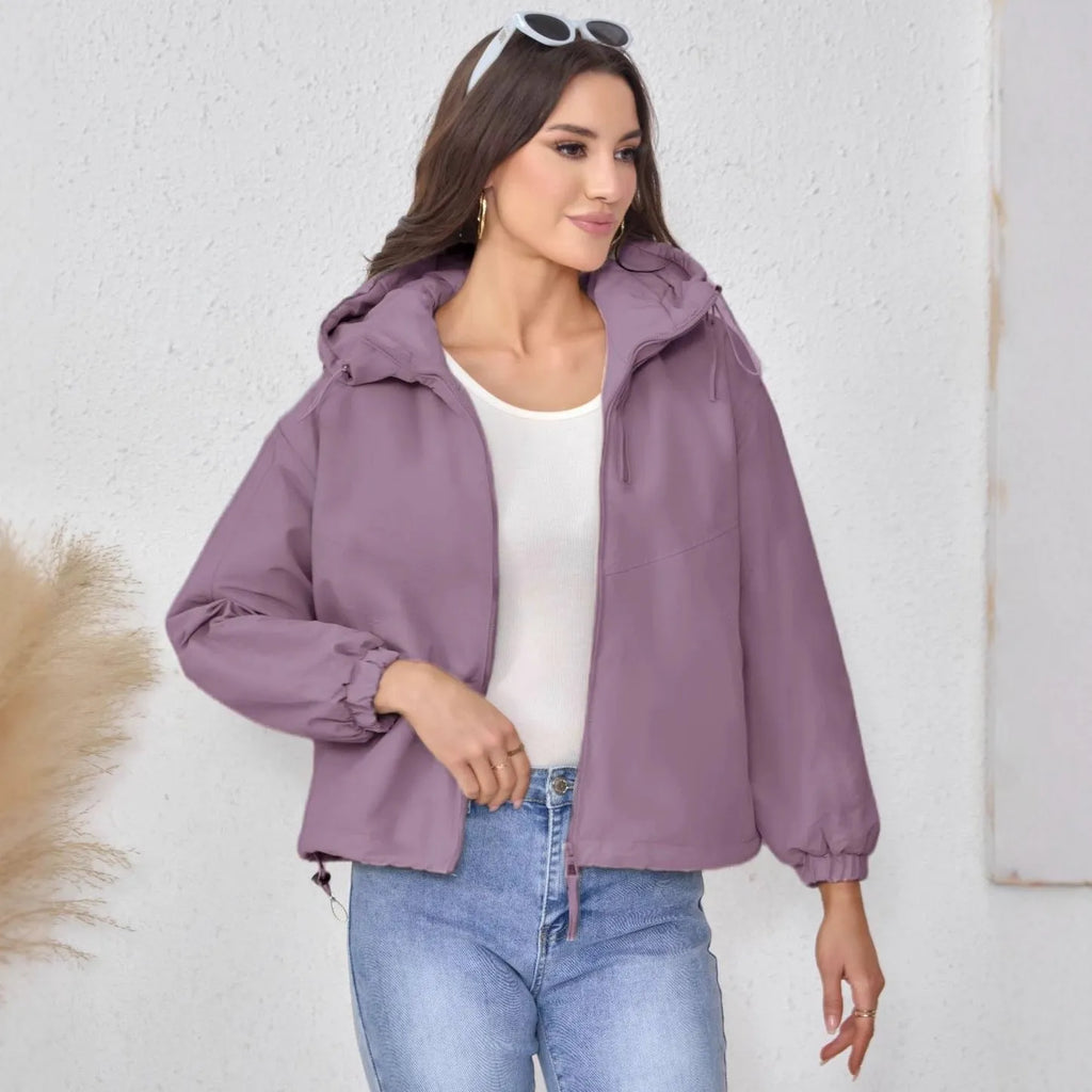Women's loose fit hooded shell jacket in polyester, shown in grey, black, or purple.