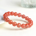 Natural South Red Cherry Agate scattered bead bracelet showing polished gemstone beads on a wrist.