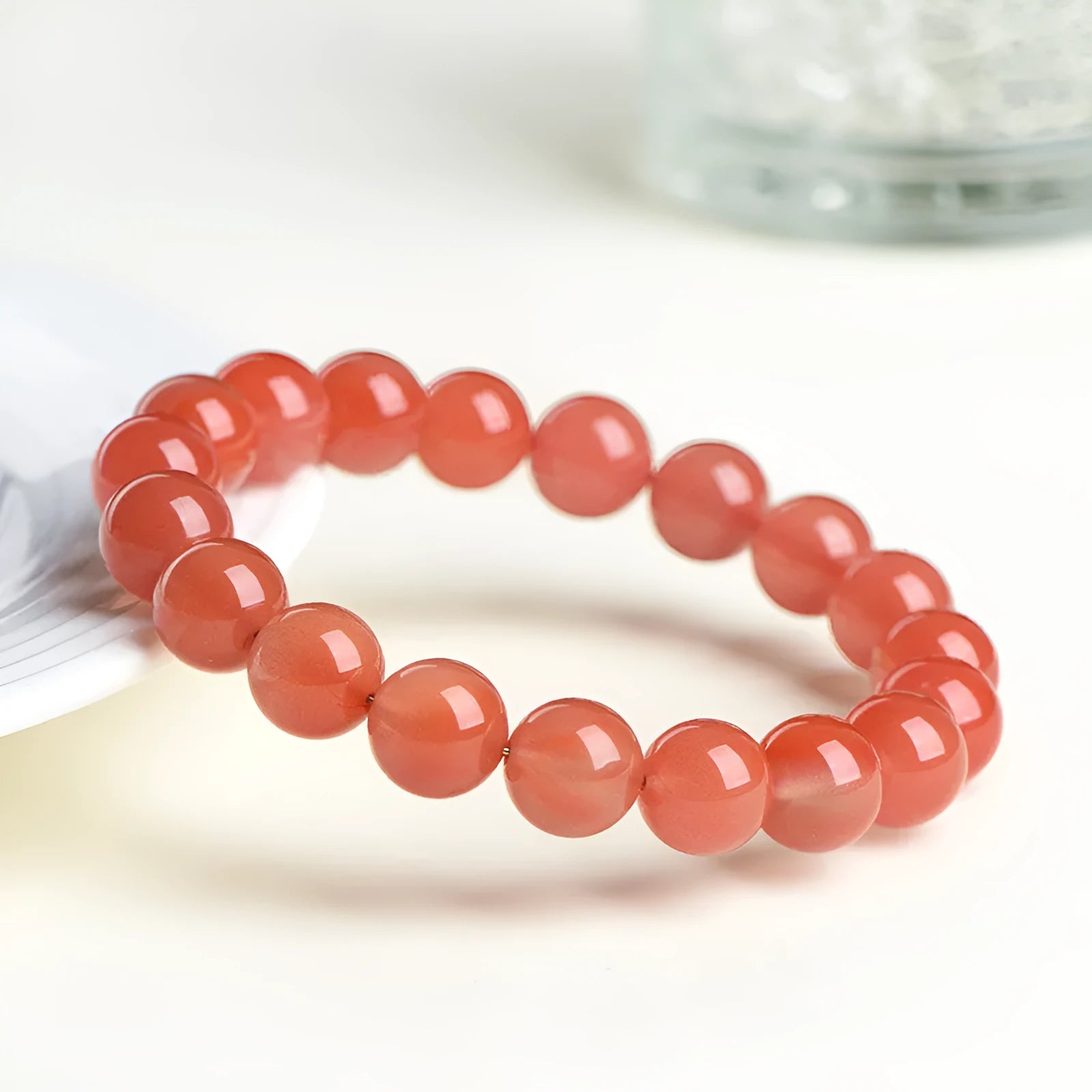 Natural South Red Cherry Agate scattered bead bracelet showing polished gemstone beads on a wrist.