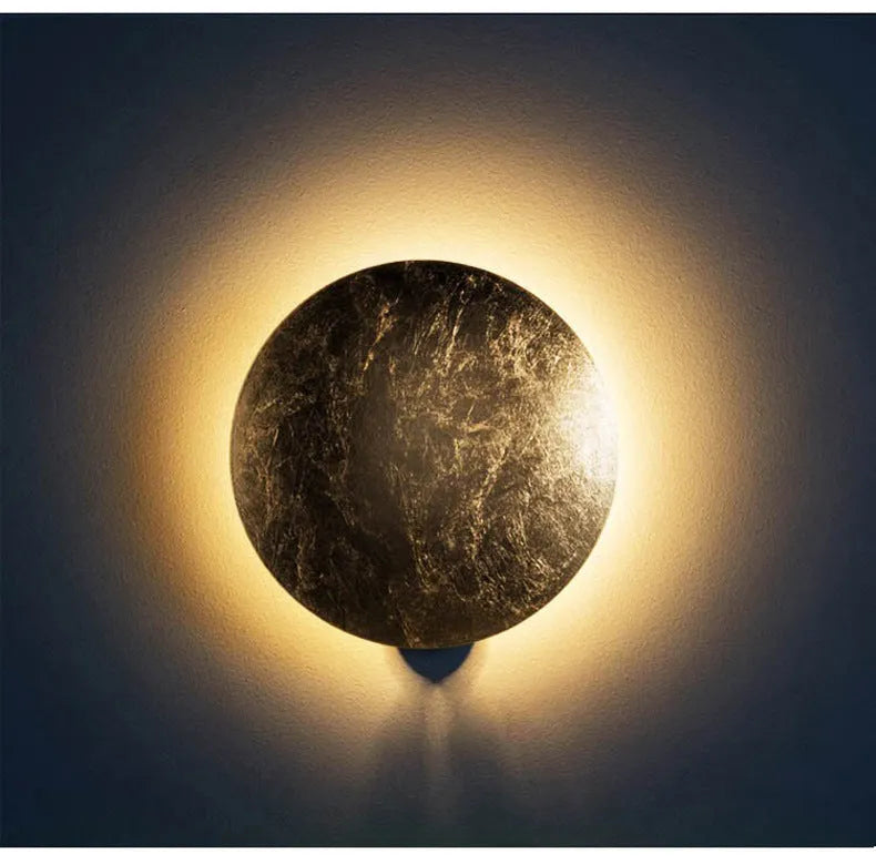 Modern minimalist aluminium bedside lamp in gold and black, shown in 20cm and 25cm diameter options.