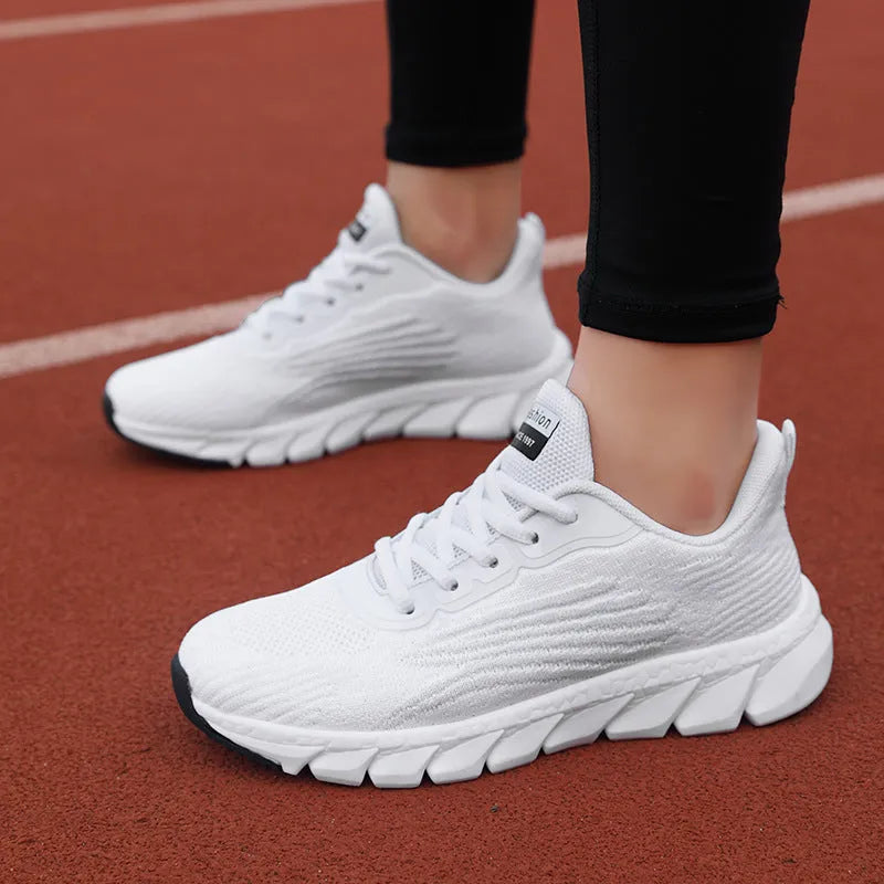 Women's black and white casual running sneakers with cross strap design and MD sole