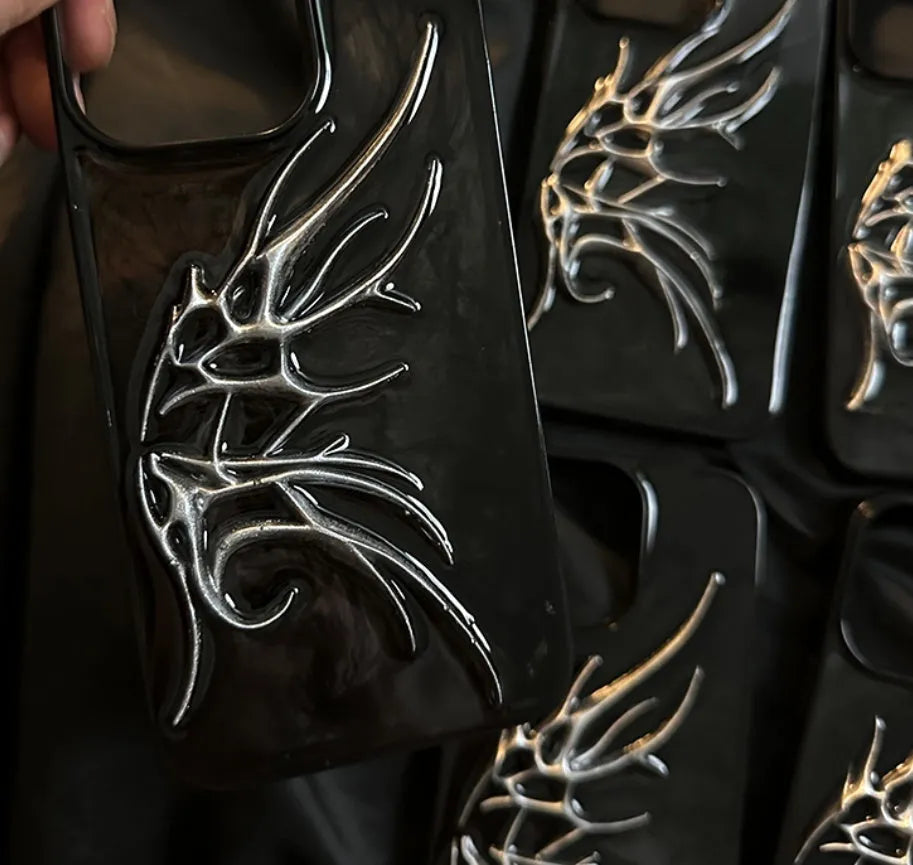 Black iPhone case with three-dimensional blurred wings design showing raised edges and precise port cutouts
