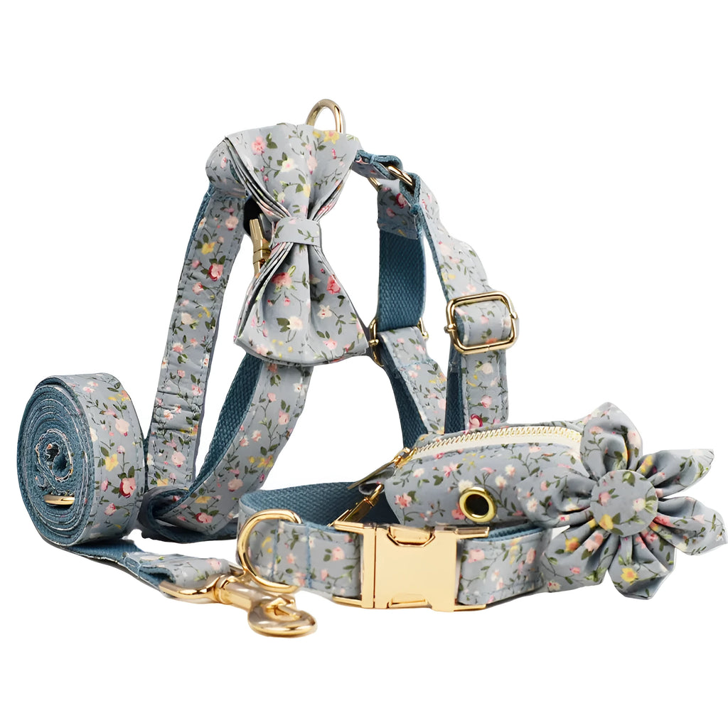 Blue floral patterned dog collar set with leash, bow tie, vest, and poop bag on a white background