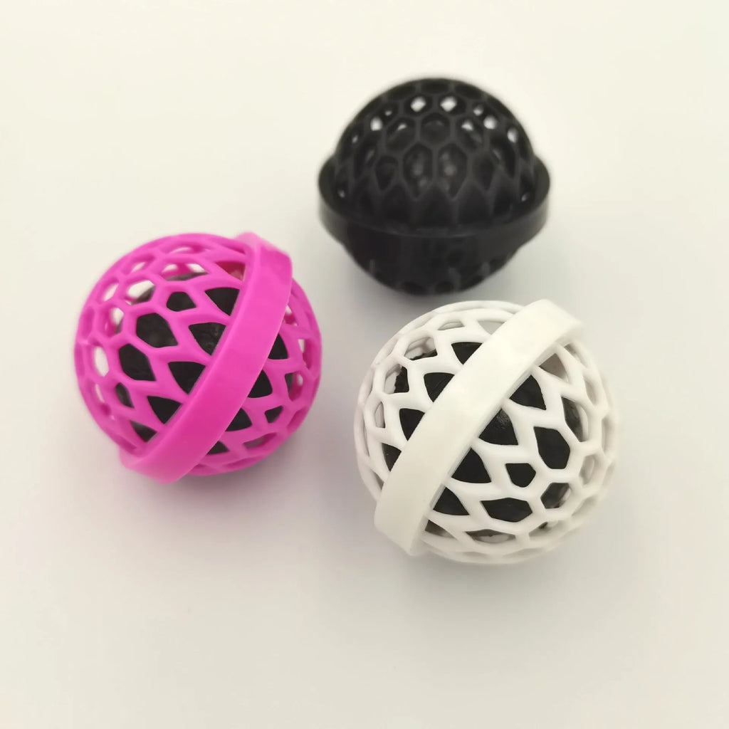 Reusable bag cleaning ball in pink colour on a clean surface
