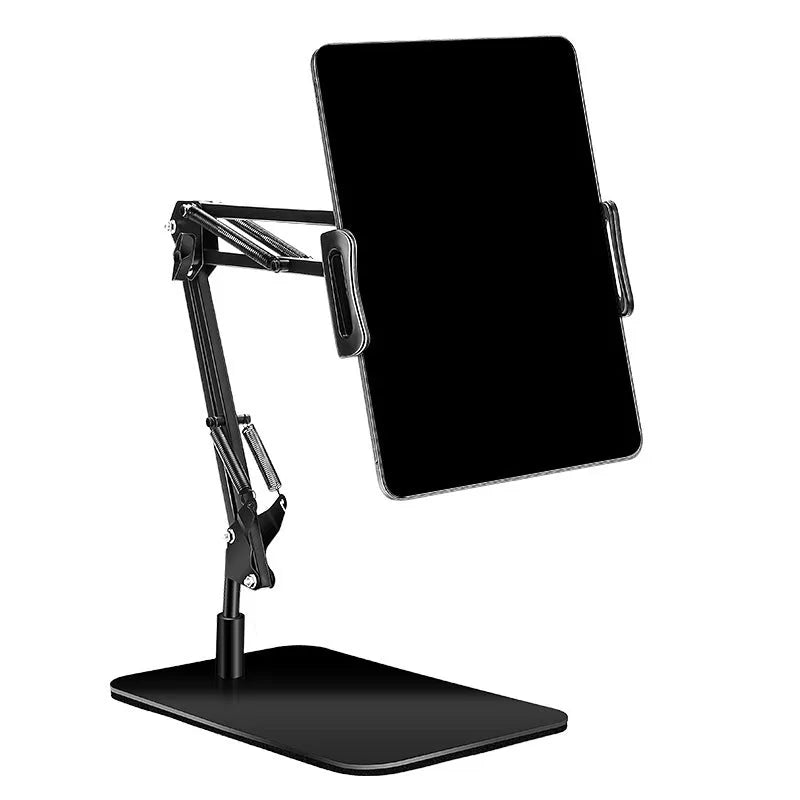 Black universal phone stand with long rotating metal arm and heavy circular base on a wooden desk.