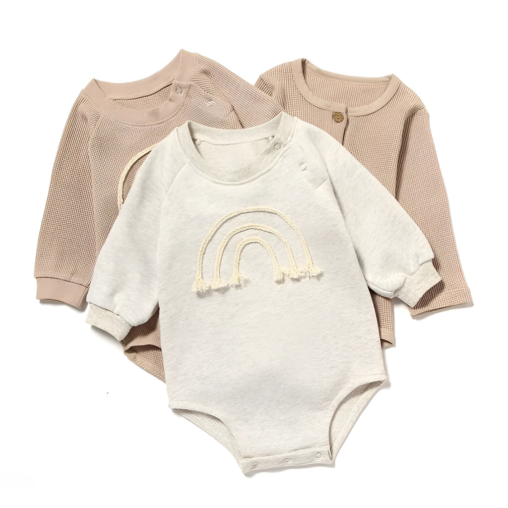 Baby wearing long sleeve waffle cotton romper with either cotton rope ties or button front closure in beige, khaki, green or blue