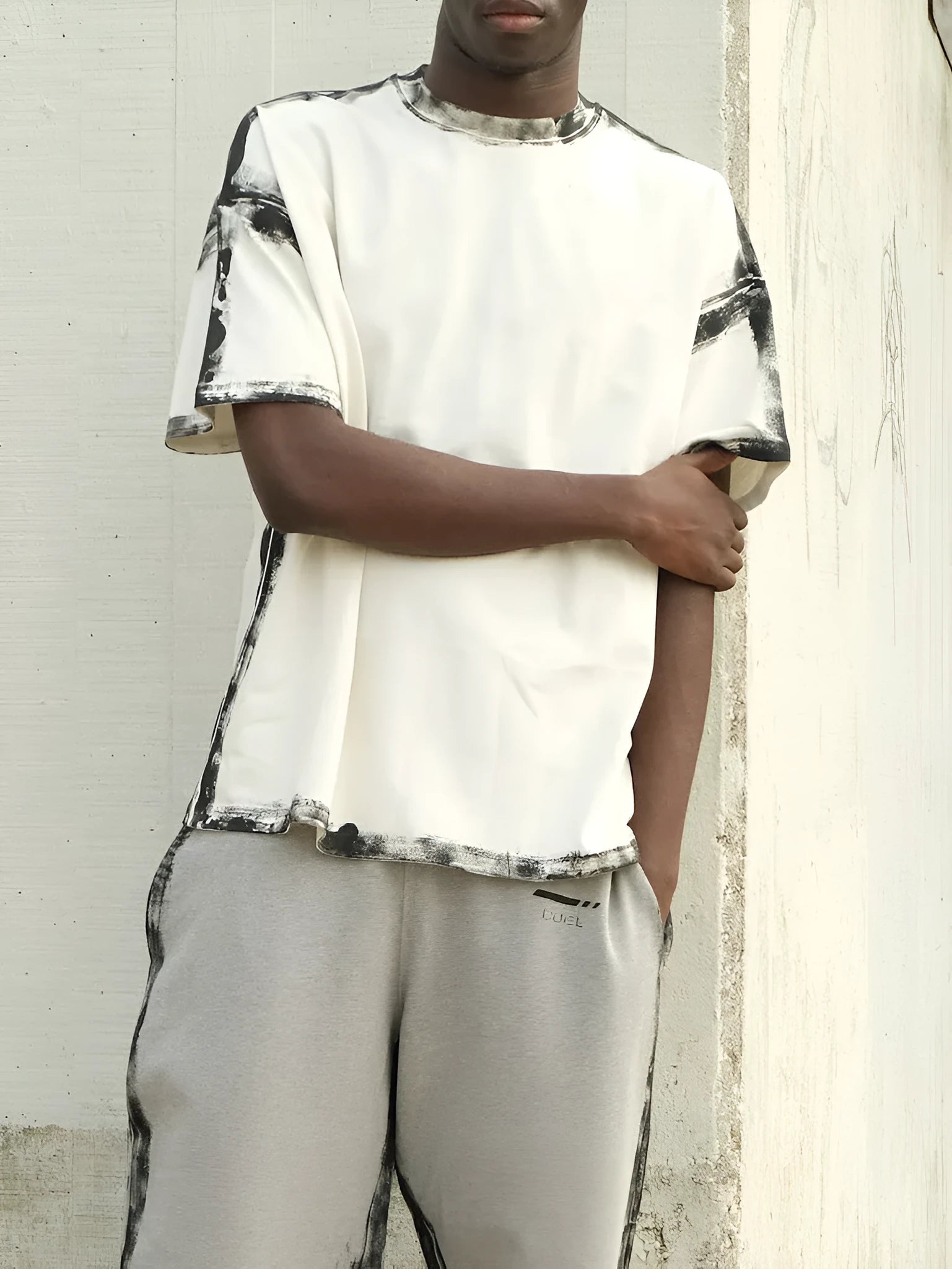 White casual short sleeve top with a draped print design on a hanger.