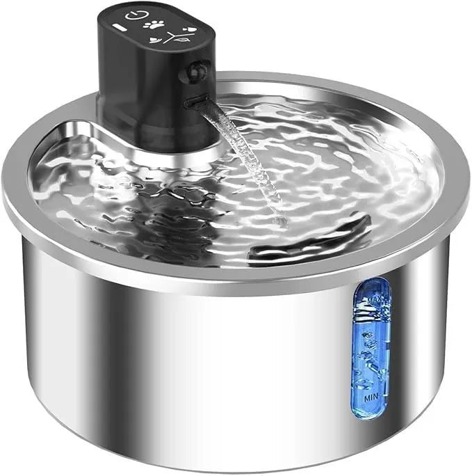 White stainless steel pet water fountain with digital thermostat base on a wooden table.