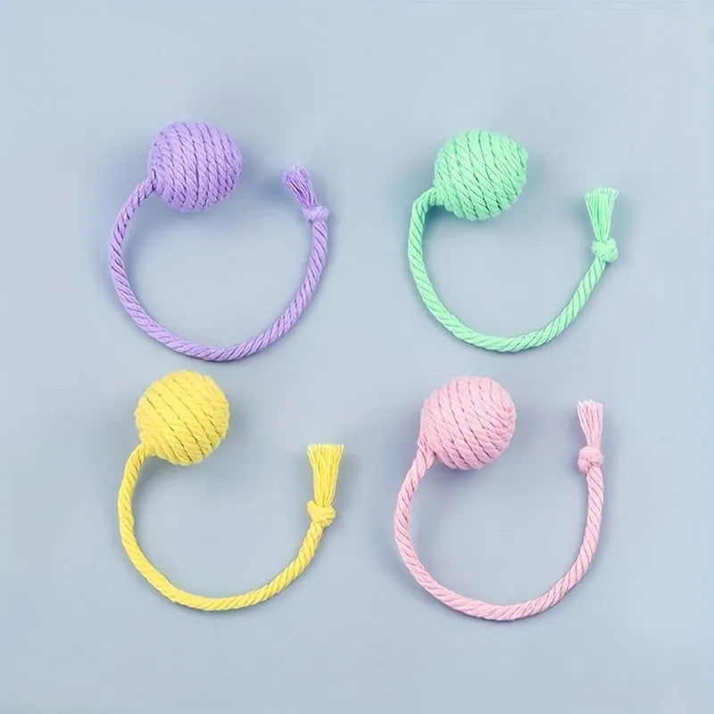 Cat toy ball with rope attached in green, pink, purple or yellow colour with internal bell