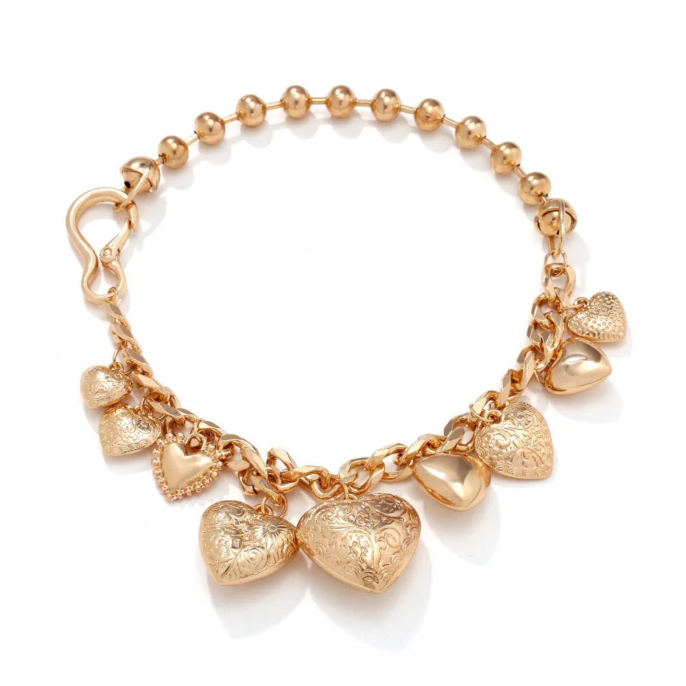 Gold carved heart pendant necklace on an adjustable metal chain.