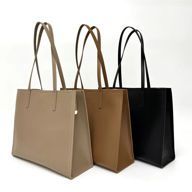 Women's brown genuine leather one shoulder handbag with horizontal square shape showing interior organisation compartments