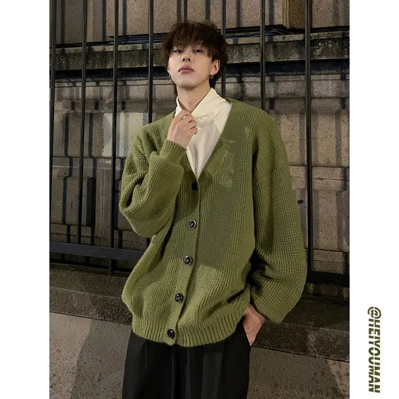 Men's solid colour V-neck knitted cardigan sweater in a loose fit on a hanger.