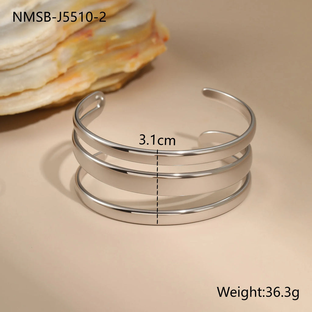 Women's geometric stainless steel bracelet with simple opening clasp in gold tone finish