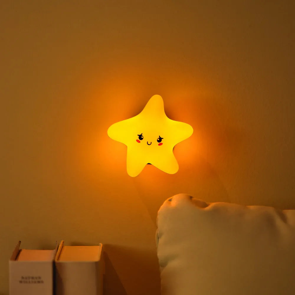 Moon XINGX Cloud silicone lamp with warm light, magnetic suction base, and cartoon design on a bedside table