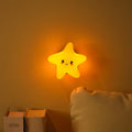 Moon XINGX Cloud silicone lamp with warm light, magnetic suction base, and cartoon design on a bedside table