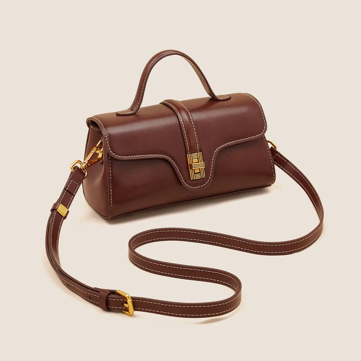 Niche retro Cambridge messenger bag in brown cow leather with lock detail and clamshell opening