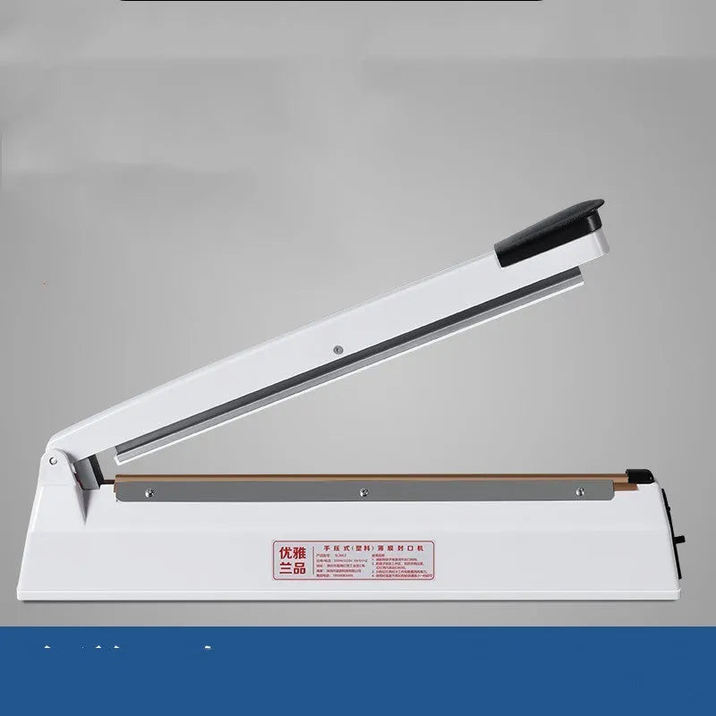 Heat film heat shrinkable bag sealing machine with 40cm sealing length and hot air gun on a workbench