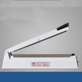 Heat film heat shrinkable bag sealing machine with 40cm sealing length and hot air gun on a workbench