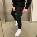 Man wearing loose-fit light blue casual trousers with a patch pocket and elasticated lace waistband