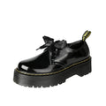 Women's black leather shoes with a thick sole, cross strap, and lace-up closure.