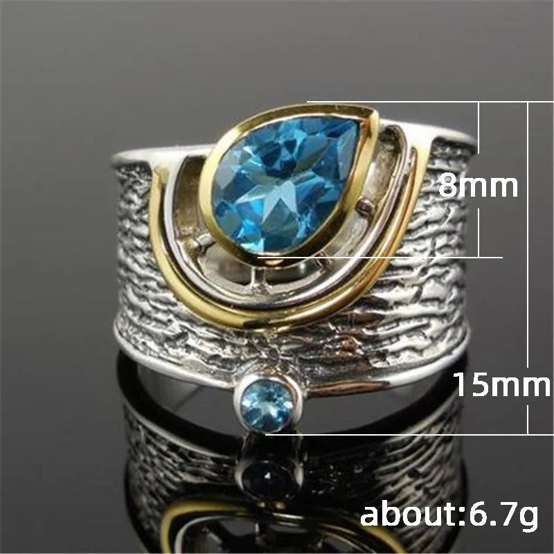 Blue zircon Chinese style women's ring with inlaid design showing drop shape silhouette