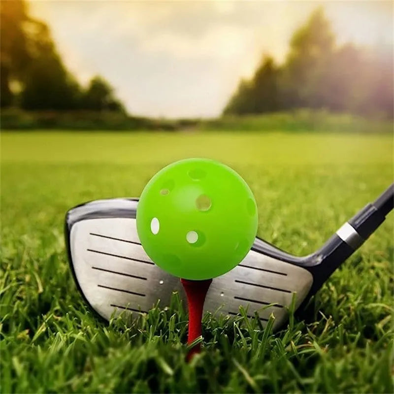 Assorted multi-colour 42mm golf practice balls with a net bag, shown next to practice putting holes.