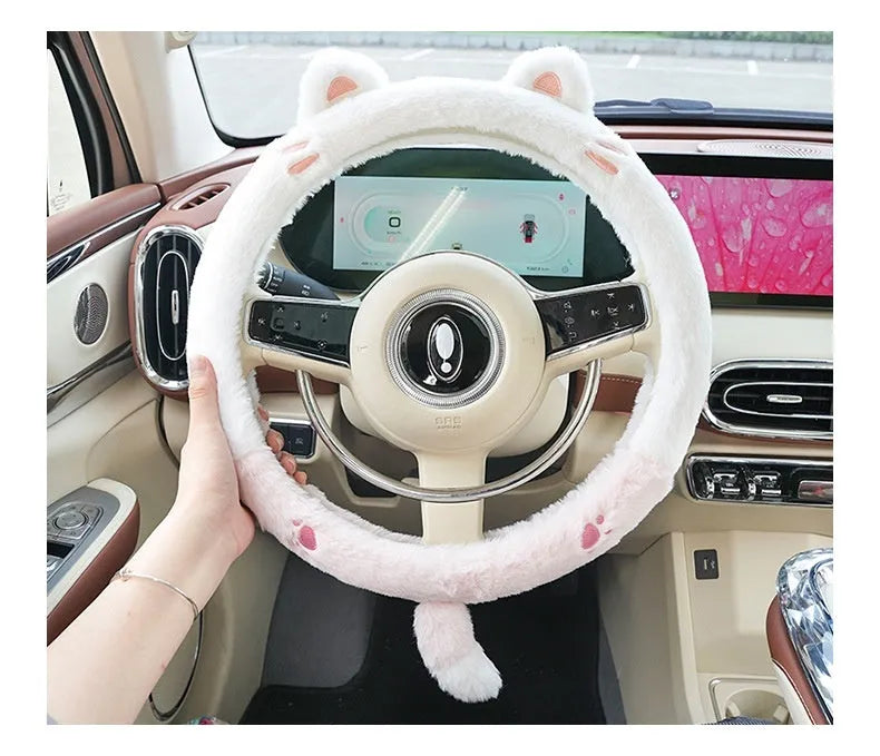 Plush faux fur steering wheel cover with embroidered cartoon bear face, fitted on a car steering wheel