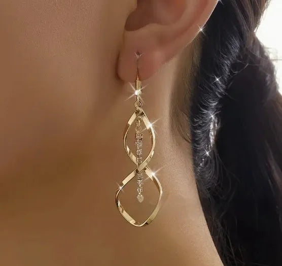 Gold geometric spiral earrings with ellipse elements and electroplated finish