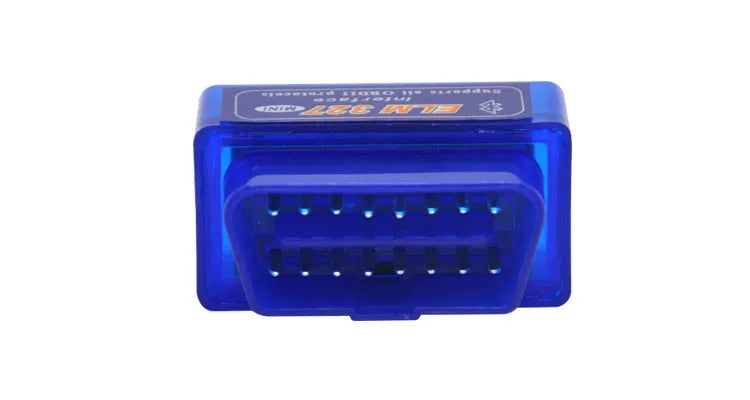 Small black ELM327 OBD2 Bluetooth diagnostic scanner next to a vehicle's OBD2 port.