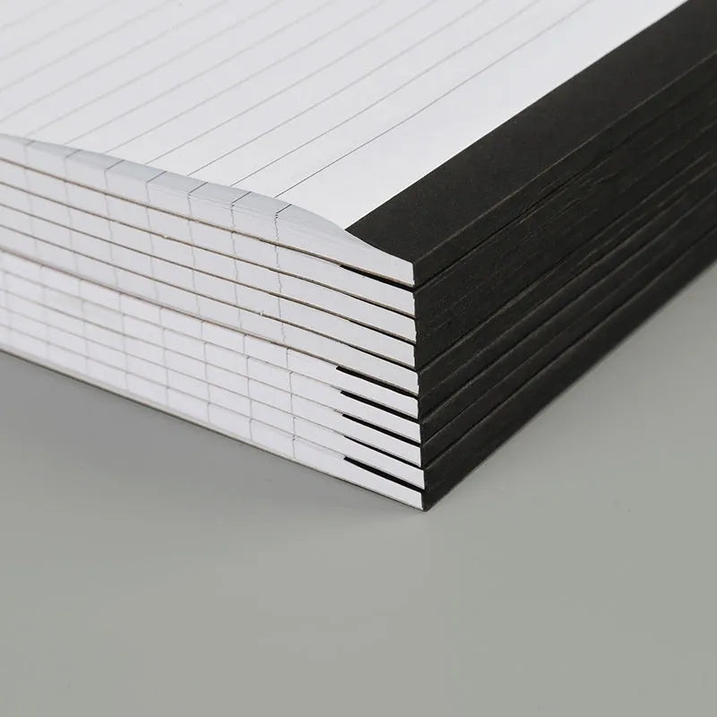 A4 paper cover notebook with grid-lined ivory pages and wireless adhesive binding.