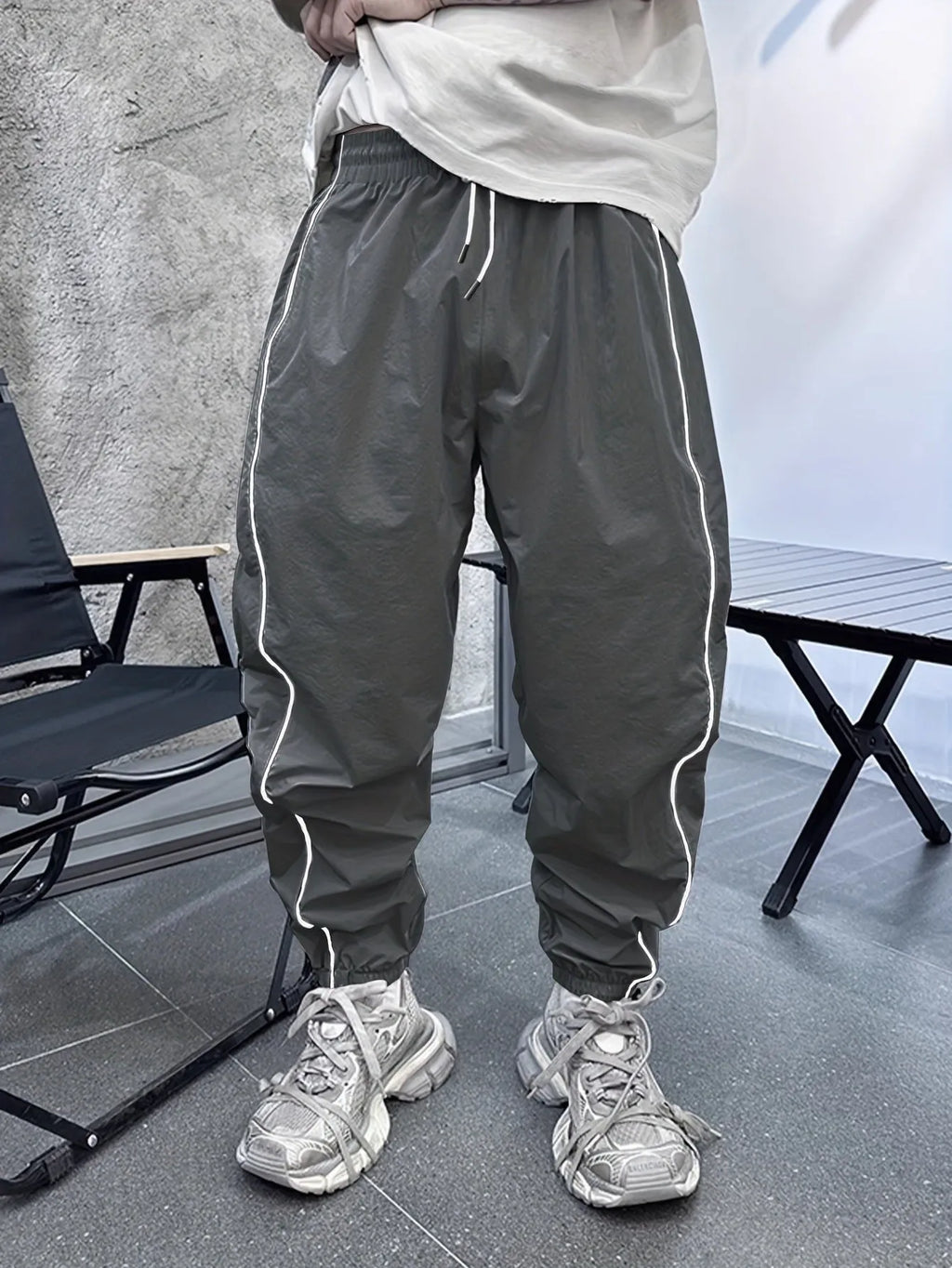 Men's blue bamboo fibre casual sports trousers with a loose, cropped fit on a neutral background.