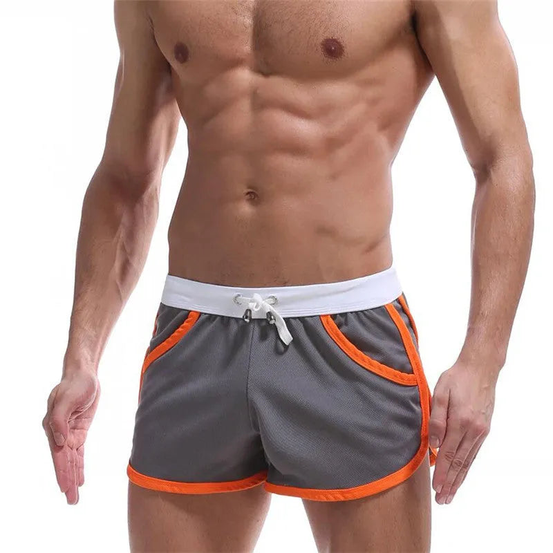 Summer men's quick-drying polyester beach sports shorts in green, with elastic waistband, front view