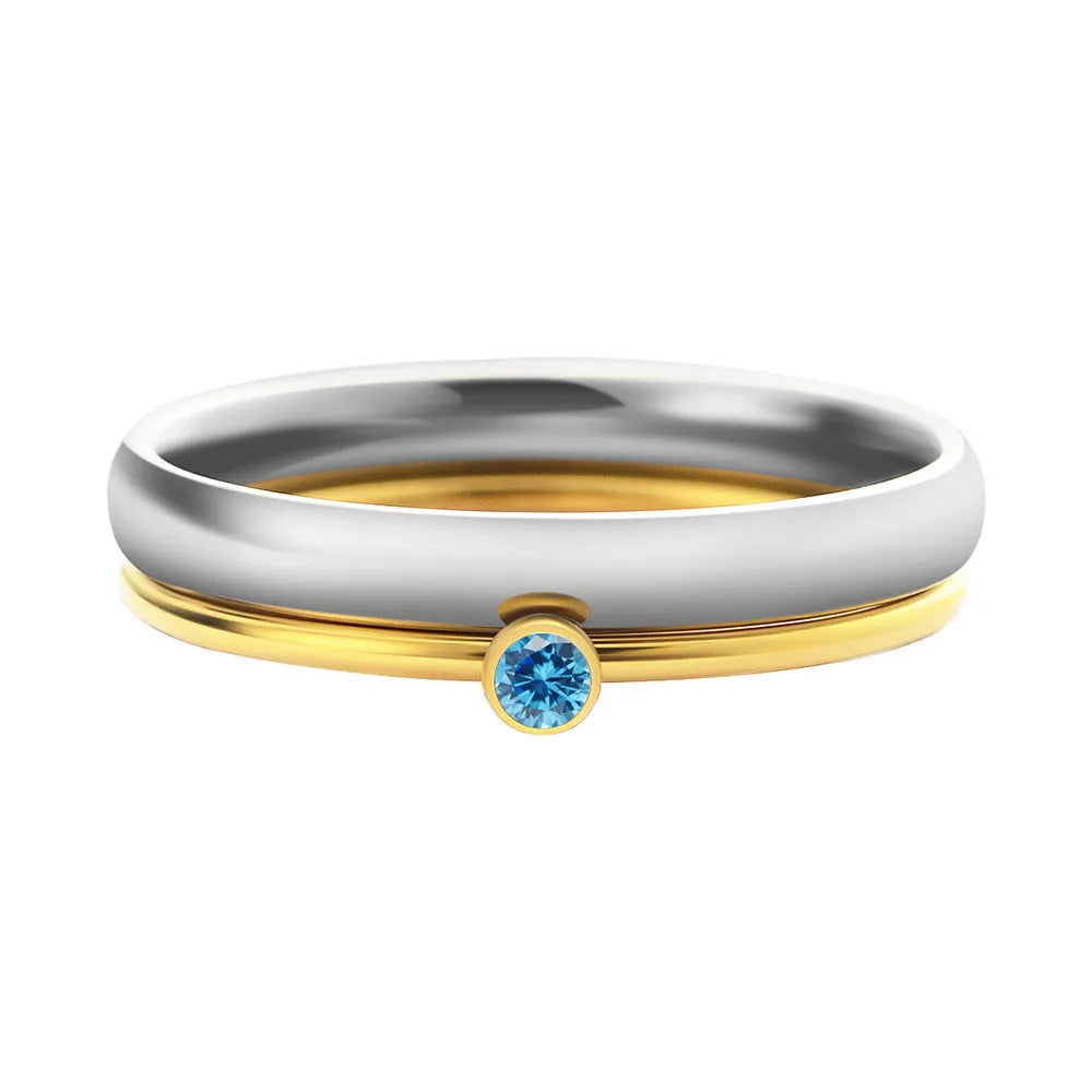 Close-up of a titanium steel engraved ring with a December colour birthstone, showing geometric design.